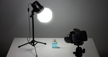 Godox Litemons LC30-series tabletop LED light with diffusion dome on a stand above a product table