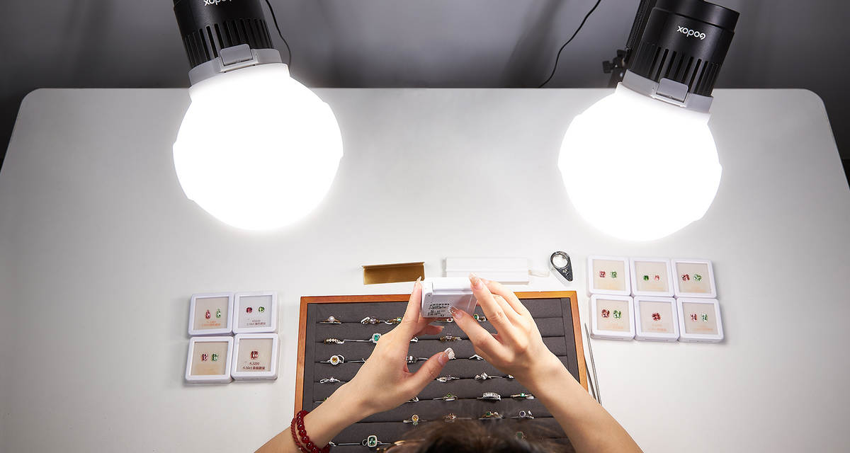 Two Godox Litemons LC30-series domed LED lights over a jewellery table