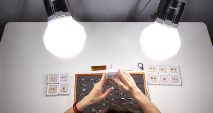 Two Godox Litemons LC30-series domed LED lights over a jewellery table