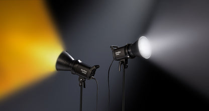 Two Godox SL60II-series LED video lights on stands, one casting warm light and one casting white light