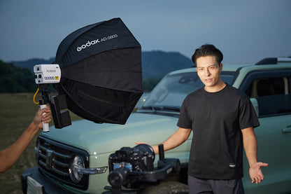 Godox ML60II Bi LED video light with a Godox AD-S60S softbox on a handheld support outdoors