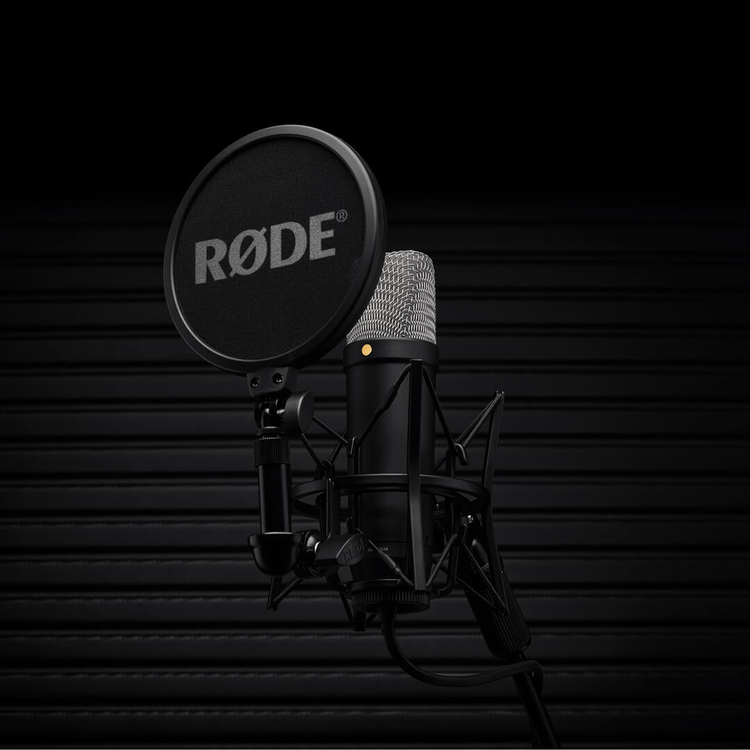Black RØDE NT1 5th Generation microphone with shock mount and pop filter against a dark background