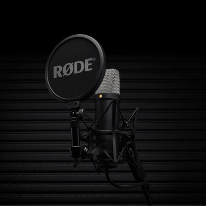 Black RØDE NT1 5th Generation microphone with shock mount and pop filter against a dark background