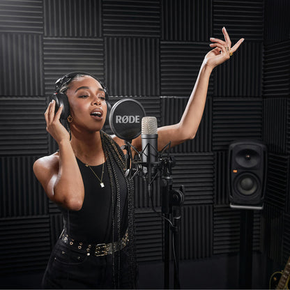 Vocalist recording with the black RØDE NT1 Signature Series studio condenser microphone