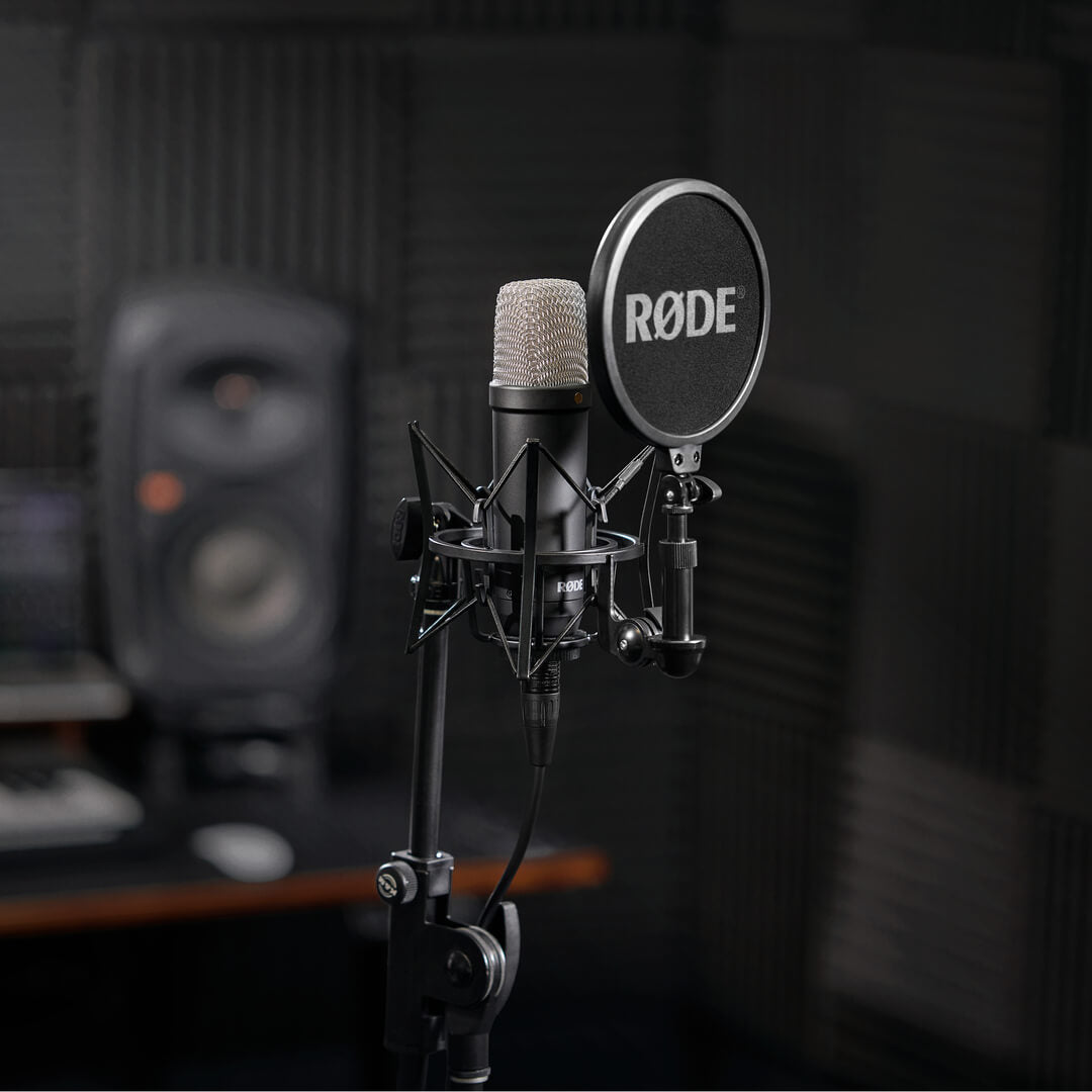 Black RØDE NT1 Signature Series on a stand with SM6 shock mount and pop filter in a recording studio