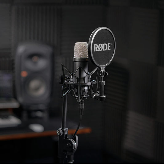 Black RØDE NT1 Signature Series on a stand with SM6 shock mount and pop filter in a recording studio