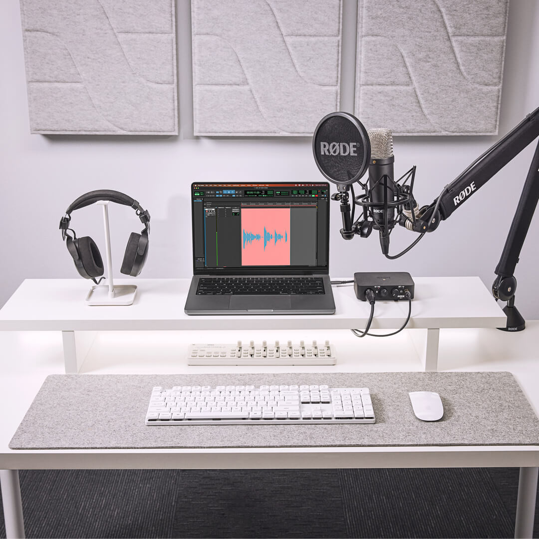 RØDE NT1 Signature Series on a boom arm in a desk recording setup with laptop and audio interface (arm and interface shown are not included)